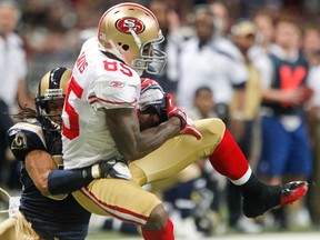 Rams cornerback Josh Gordy tackles 49ers tight end Vernon Davis in St. Louis, Miss., Jan. 1, 2012. (SARAH CONARD/Reuters)