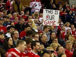 A fan flashes a sign during the World Junior Hockey Championship match between Team Canada and Team USA at Rexall Place in Edmonton, Alta., Dec. 31, 2011. (CODIE McLACHLAN/QMI Agency)