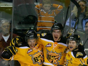 Wheat Kings (L tp R) Ryley Miller, Mark Stone and Shayne Wiebe celebrate a third-period goal during a game against the Calgary Hitmen in late January. (JIM WELLS/QMI AGENCY)