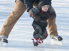Bryan Clark takes his two-year-old son Maverick for his first skate at the duck pond in Winnipeg's Assiniboine Park. (BRIAN DONOGH/Winnipeg Sun)