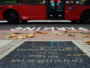 A bus passes a plaque in memory of 1993 murder victim Stephen Lawrence, where he was killed in Eltham, south east London in this November 14, 2011 photo. (REUTERS/Luke MacGregor)