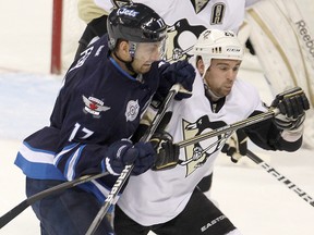 Winnipeg Jets right winger Eric Fehr (left) checks Pittsburgh Penguins left winger Steve Sullivan Friday, Dec. 23, 2011. (BRIAN DONOGH/Winnipeg Sun)