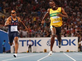 Usain Bolt (right) plans to launch his run-up to defending his 100 and 200 metres titles at the 2012 Olympics with tune-up races in Jamaica next month. (REUTERS/Michael Dalder/Files)