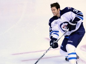 The Winnipeg Jets' Mark Flood loses his helmet during the second period of play in their NHL game against the Colorado Avalanche in the Pepsi Center Denver December 27, 2011. REUTERS/Evan Semon (UNITED STATES - Tags: SPORT ICE HOCKEY)