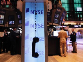 A phone hangs above the floor of the New York Stock Exchange shortly after the opening of the market August 19, 2011.  Bill Gross, the manager of the world's largest bond fund, is calling the current market environment 'paranormal.' REUTERS/Lucas Jackson