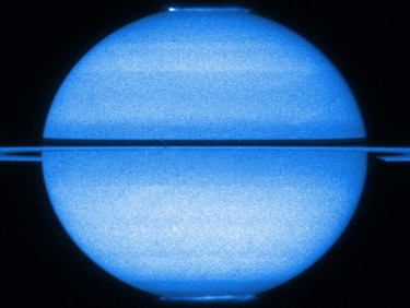 This unique image from NASA/ESA's Hubble Space Telescope from early 2009 features Saturn with the rings edge-on and both poles in view, offering a double view of its fluttering auroras, in this image release by NASA on March 22, 2011. (NASA/ESA/STScI/University of Leicester/Handout)