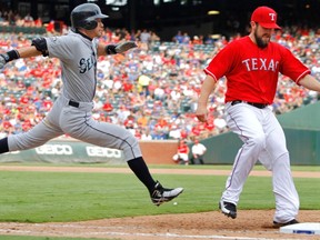 Seattle Mariners' Ichiro Suzuki lunges toward first base as Texas Rangers pitcher Darren O'Day (R) makes the out in the eighth inning of their MLB American League baseball game in Arlington, Texas, Sept., 24, 2011. (REUTERS/Tim Sharp)