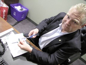 Councillor Doug Ford cut up his free parking pass and urged the Toronto Parking Authority to stop doling out the perk to Toronto council members. (DON PEAT, Toronto Sun)