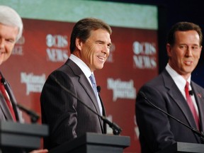 Republican presidential candidates (L-R), former U.S. House of Representatives Speaker Newt Gingrich, Texas Governor Rick Perry and former Pennsylvania Senator Rick Santorum, share a smile during the Republican party presidential debate in Spartanburg, South Carolina, November 12, 2011. (REUTERS/Chris Keane)
