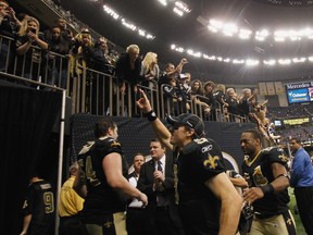 Drew Brees leads the New Orleans Saints off the field at the Superdome after their final regular-season game last Sunday. The Saints are the hottest team in the NFL heading into the post-season. (US Presswire)
