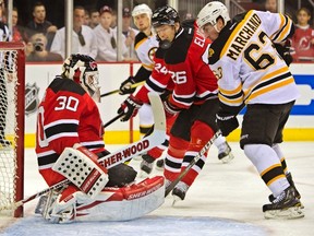 Devils goaltender Martin Brodeur makes a save in front of Bruins forward Brad Marchand at the Prudential Center in Newark, N.J., Jan. 4, 2012. (RAY STUBBLEBINE/Reuters)