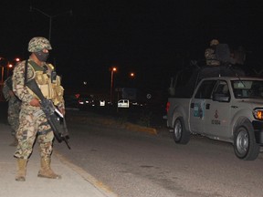 Soldiers stand guard outside a prison after a fight between rival gangs in Altamira, Tamaulipas January 4, 2012. (REUTERS/Diario El Sol De Tampico)