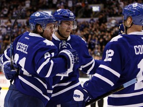 Tim Connolly, Joffrey Lupul and Phil Kessel of the Toronto Maple Leafs celebrate Kessel goal against the Winnipeg Jets on Thursday. (Dave Abel/ Toronto Sun)