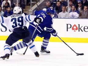 Leafs forward Joffrey Lupul gets around Tobias Enstrom of the Winnipeg Jets at the Air Canada Centre on Thursday night. Lupul drew an assist in Toronto’s 4-0 win.(Dave Abel, Toronto Sun)