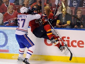 Montreal Canadiens' Max Pacioretty (67) checks Florida Panthers' Kris Versteeg during the first period of their NHL hockey game in Sunrise, Florida December 31, 2011. (REUTERS/Doug Murray)