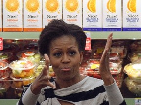 U.S. first lady Michelle Obama gestures after being introduced at a Walgreens store in Chicago's Englewood neighborhood October 25, 2011. REUTERS/Frank Polich