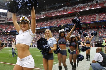 Houston Texans cheerleaders sport military style outfits as the Texans honored the military before their NFL football game against the Cleveland Browns in Houston November 6, 2011.   REUTERS/Richard Carson
