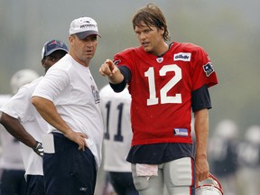 New England Patriots quarterback Tom Brady (R) and quarterback coach Bill O'Brien talk during the first official day of the team's NFL football training camp in Foxborough, Massachusetts July 29, 2010. Penn State University has named O'Brien its new football coach. REUTERS/Brian Snyder
