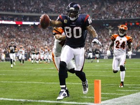 Houston Texans’ Andre Johnson scores a touchdown on a pass reception in front of Cincinnati Bengals’ Adam Jones (right) during the third quarter of their  AFC wild card game on Saturday. (Reuters)
