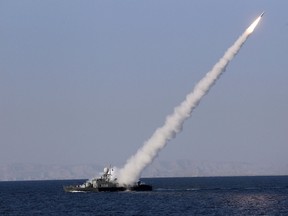 A new medium-range missile is fired from a naval ship during Velayat-90 war game on Sea of Oman near the Strait of Hormuz in southern Iran January 1, 2012. Iran test-fired a new medium-range missile, designed to evade radars, on Sunday during the last days of its naval drill in the Gulf, the official IRNA news agency quoted a military official as saying. REUTERS/Jamejamonline/Ebrahim Norouzi