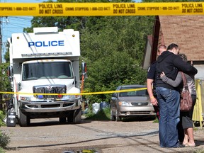 A police officer (in black top) comforts a distraught woman that arrived at the scene of a fatal fire at the Bethany Senior Citizens Home, 9920 - 83 Ave. in Edmonton, Aug. 2, 2011. DAVID BLOOM EDMONTON SUN  QMI AGENCY