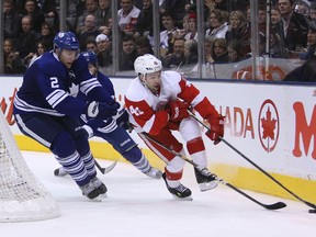 Red Wings’ Chris Connor is chased by Leafs defenceman Luke Schenn behind the net during last night’s game at the ACC. (MICHAEL PEAKE/Toronto Sun)