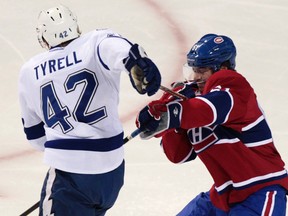 Montreal Canadiens' Raphael Diaz battles with Tampa Bay Lightning's Dana Tyrell (42) during the first period of NHL hockey action in Montreal January 7, 2012.  (REUTERS/Christinne Muschi)