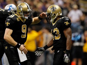 The Saints' Darren Sproles (right) celebrates with teammate Drew Brees after scoring a touchdown in the fourth quarter against the Detroit Lions on Saturday night. (AFP)