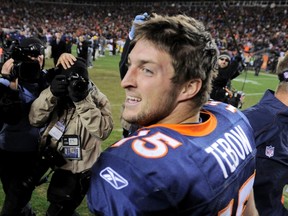 Denver Broncos quarterback Tim Tebow celebrates after his team defeated the Pittsburgh Steelers in overtime in the AFC wild card playoff game on Sunday. (Reuters)