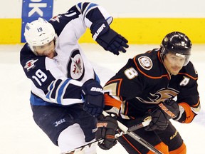 Jets centre Jim Slater (left) ties up Anaheim Ducks right-winger Teemu Selanne on Dec. 17 in Winnipeg. (BRIAN DONOGH/Winnipeg Sun files)