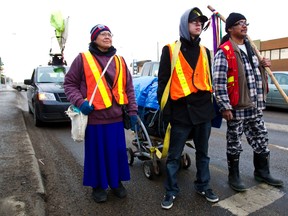 (From left) Audrey Auger, Timothy Auger and Kevin Soto are seen along 118 Avenue as they participate in a walk called "Highway of Hope" that started in Prince George, B.C. Monday's walk will wrap up at the Boyle Street Co-op in Edmonton on Monday, January 2, 2012. The walk will loop back to Prince George. CODIE MCLACHLAN/EDMONTON SUN QMI AGENCY
