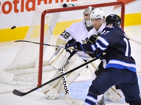 Winnipeg Jets' Eric Fehr (17) reaches for a rebound in front of Pittsburgh Penguins goaltender Marc-Andre Fleury during the first period of their game in Winnipeg December 23, 2011. (FRED GREENSLADE/Reuters)
