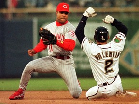Cincinnati Reds shortstop Barry Larkin moves to tag out Milwaukee Brewers baserunner Jose Valentin in this file photo. (REUTERS FILES/Allen Fredrickson)