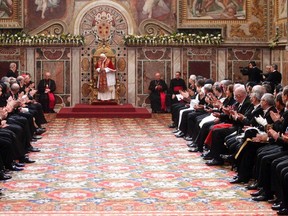 Pope Benedict XVI is welcomed during an audience with the diplomatic corps at the Vatican Jan. 9, 2012. REUTERS/Pier Paolo Cito/Pool