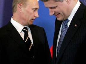 Russia's Vladimir Putin (L) and Stephen Harper take their seats at the start of their bilateral meeting in St. Petersburg July 15, 2006, on the eve of the G8 summit. REUTERS/Chris Wattie