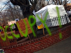The word "Occupy!" is seen on a window at an "Occupy" camp in Manchester, N.H. Jan. 8, 2012. REUTERS/Eric Thayer