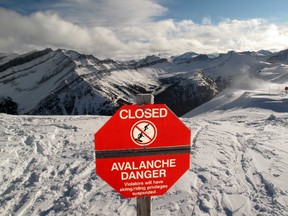 An avalanche warning sign informs skiers of a closed run following a dump of  freshly fallen snow in Lake Louise, Alberta November 28, 2011.    REUTERS/Mike Blake
