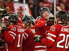 Team Canada celebrates their 3-2 victory over Team USA during the third period of the Canada-USA game at the IIHF world junior hockey at Rexall Place in Edmonton on December 31, 2011. (CODIE MCLACHLAN/QMI Agency)