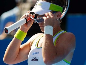 Samantha Stosur adjusts her glasses during her match against Francesca Schiavone at the Sydney International on Monday, Jan. 9, 2012. (REUTERS/Daniel Munoz)