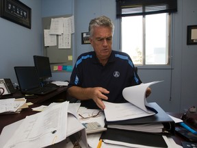 Argos GM Jim Barker, seen here in his office before a Christmas eve fire destroyed the building in Mississauga. No one was hurt but Barker lost a number of treasured mementos and coaching records. (QMI FILE PHOTO)