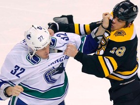 Bruins winger Nathan Horton and Canucks winger Dale Weise fight during first period action in Boston on Saturday, Jan. 7, 2012. (REUTERS/Adam Hunger)