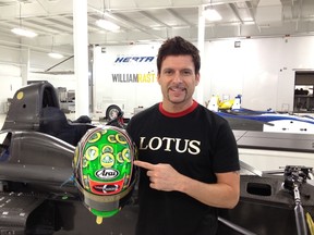 Alex Tagliani shows off his racing helmet, freshly coated with his new sponsor's stickers.