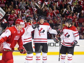 Mark Stone celebrates a goal with teammates Jonathan Huberdeau, left, and Ryan Strome. Stone and Oil Kings captain Mark Pysyk are normally enemies but have bonded somewhat on Team Canada. (Edmonton Sun file)