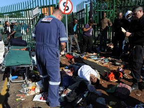 Paramedics attend to one of the 20 injured during a stampede by students trying to register at the University of Johannesburg January 10, 2012. REUTERS/Adrian de Kock