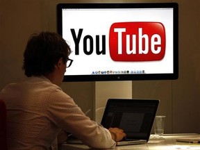 A visitor is seen at the YouTube stand during the annual MIPCOM television program market in Cannes in this Oct. 3, 2011 file photo. REUTERS/Eric Gaillard