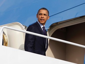U.S. President Barack Obama looks back as he boards the Air Force One at Andrews Air Force Base near Washington December 23, 2011. (REUTERS/Jason Reed)