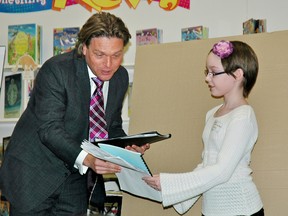 Alberta Education Minister Thomas Lukaszuk receives a gift from Trinity Locke, 9, a grade four student at Dunluce School, 11735 - 162 ave. NW. Lukaszuk announced a 10-point plan for education Tuesday after hearing additional feedback during a new round of consultation surrounding the proposed Education Act. TANARA McLEAN/EDMONTON SUN  QMI AGENCY