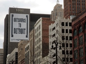 A larger banner reading "Outsource to Detroit" is seen on the side of a building on Woodward Ave in downtown Detroit, January 7, 2012. REUTERS/Rebecca Cook