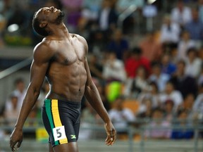 Usain Bolt of Jamaica walks without his shirt after being disqualified for a false start during the men's 100 metres final at the IAAF World Championships in Daegu August 28, 2011. (REUTERS/Phil Noble)