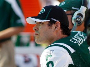 New York Jets quarterback Mark Sanchez watches from the bench in the fourth quarter play against the Miami Dolphins during their NFL football game in Miami, Florida, January 1, 2012. (REUTERS/Joe Skipper)